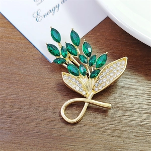 Elegant gold plated emerald bouquet brooch with marquise green stones and rhinestones