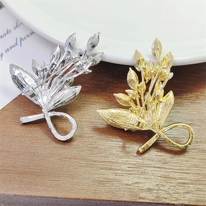 Elegant emerald-themed leaf brooches in gold and silver finish with secure pin back details