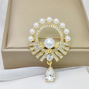 Elegant vintage pearl brooch with teardrop crystal pendant on gold metal base