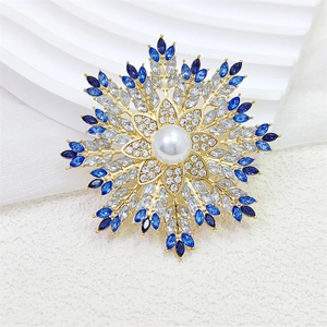 Eleganter Gold-Schneeflocken-Anstecker mit zentraler Perle und blauen Zirkonia-Steinen