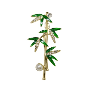 Elegant bamboo-shaped brooch with green enamel leaves, rhinestones and a white pearl accent