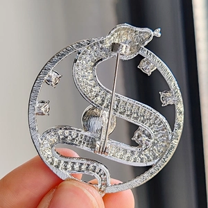 Macro shot of silver snake brooch back showing detailed needle pin clasp and metal finish