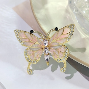 Eleganter Schmetterlingsbrosche aus Gold mit rosa Emaille-Flügeln und weißen Strasssteinen