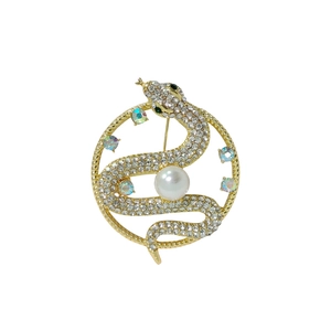 Luxurious snake brooch with white rhinestones and pearls on a gold-plated vintage base