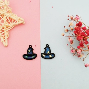 Detail of two DIY wizard hat charms with blue enamel and star glitter for jewelry making