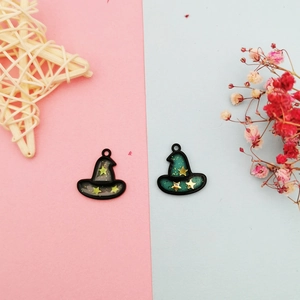 Detailed view of DIY wizard hat charms with starry patterns and glittering oil finish