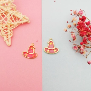 Detail view of pink wizard hat pendants with gold stars for DIY jewelry making