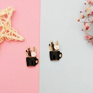 Detail of DIY floral cup charms in black enamel with white flower for earrings