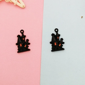Detailed close-up of two black and orange Halloween haunted house alloy charms