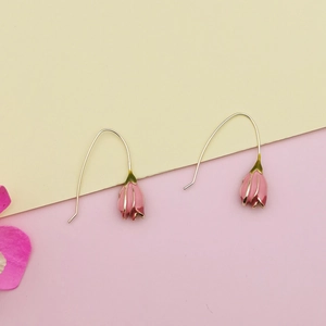 Detail of tulip petal earring charms with pink enamel finish and gold metal hooks