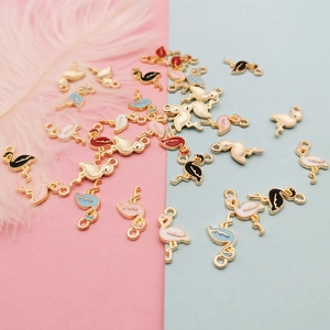 Pink and blue enamel flamingo alloy charms for DIY jewelry making on a split background