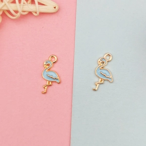 Macro detail of flamingo alloy pendants with light blue enamel finish for DIY jewelry making