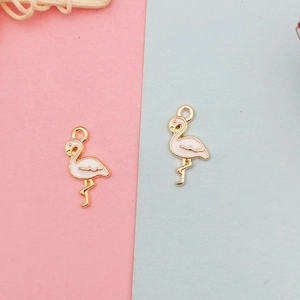 Close-up of pink flamingo enamel charms with gold plating for DIY jewelry making