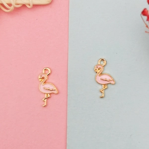 Detailed macro view of a pink enamel flamingo alloy charm for DIY jewelry making