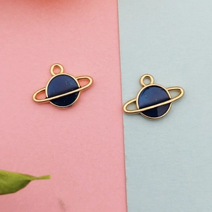 Detail of star and moon alloy charms with blue oil drip finish for DIY jewelry making