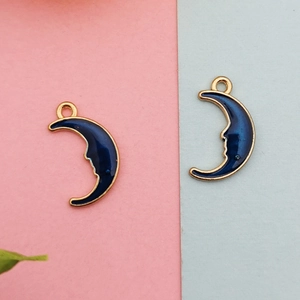 Detail view of double-sided crescent moon pendants with deep blue enamel and gold alloy frame