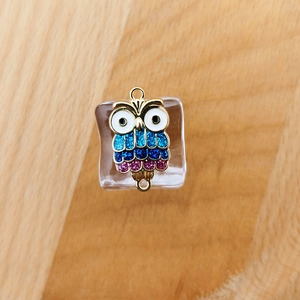 Detail showing colorful glitter owl charm connector with double loops for DIY jewelry