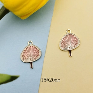 Detailed macro view of 15x20mm gold-plated pink enamel fan charms for DIY jewelry making