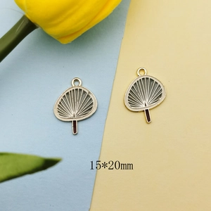 Macro view showing 15x20mm gold-plated fan charm with blue enamel for DIY jewelry