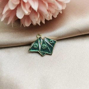 Detail of green glitter enamel charm with origami style and heart pattern for DIY jewelry