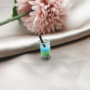 Detailed close-up of a miniature 3D bubble tea pendant with blue and green layers