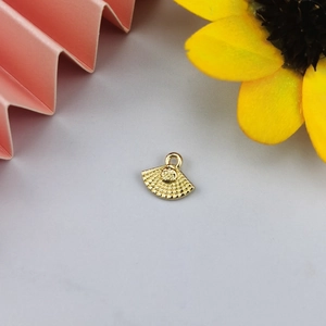 Detail of a golden alloy fan-shaped pendant with grid texture for DIY jewelry making