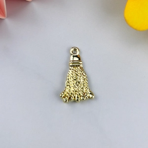 Detail of Chinese style golden tassel pendant with alloy dripping oil and woven texture