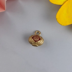 Macro shot of gold lantern pendant with Fu character for DIY jewelry making