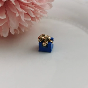 Detailansicht eines blauen Geschenkbox-Anhängers mit goldener Schleife für DIY