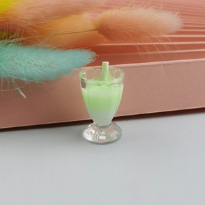 Macro view of a miniature resin dollhouse green soda glass with a tiny straw detail