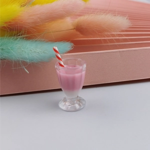 Macro shot of miniature pink dollhouse shake drink with a red striped straw