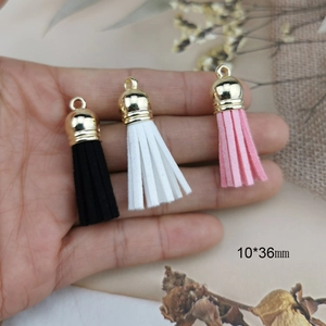 Faux suede tassel pendants in black, white, and pink with gold metal caps, 10x36mm size