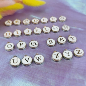 Set of 26 double-sided white enamel alphabet charms with gold metal edges for DIY jewelry
