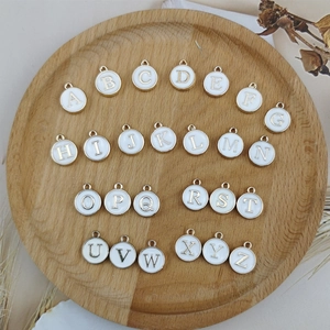 Set of 26 white enamel alphabet charms with gold metal borders for DIY jewelry