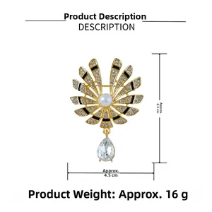Detail of gold fan brooch with clear water drop crystal and white rhinestones