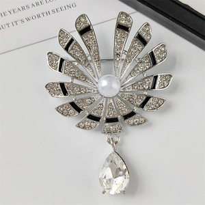 Elegant silver fan brooch with rhinestones, pearl accent, and a pear-cut crystal pendant