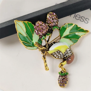 Vintage enamel strawberry and magpie brooch with purple rhinestones on golden base