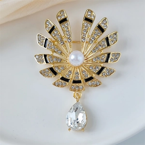 Vintage gold fan brooch with rhinestone floral details and a pear-shaped crystal pendant