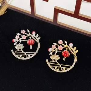Elegant Chinese lantern brooch with plum blossom and cubic zirconia on black background