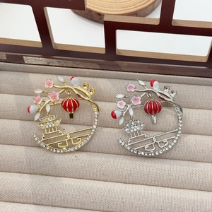 Macro detail of Chinese style lantern brooches with zircon inlay and floral motifs