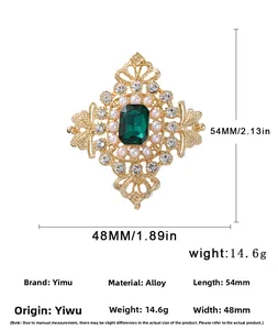 Detailed view of vintage gold alloy brooch featuring green gemstone and white pearls