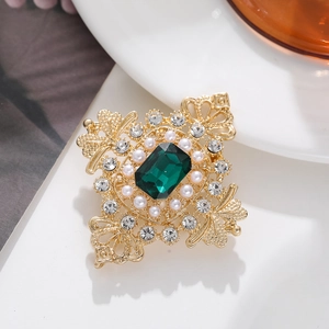 Baroque style gold brooch with emerald-cut green crystal and elegant pearl border