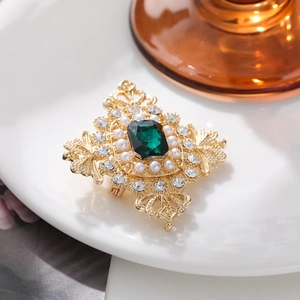 Vintage palace style brooch with emerald-cut green crystal and pearls on gold base