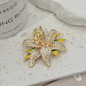 Luxury crystal flower brooch with yellow enamel on textured white stone base
