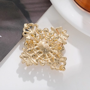 Detailed back view of vintage hollow gold crystal brooch with secure safety pin clasp