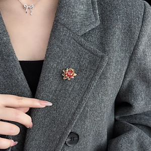 Exquisite green lotus flower brooch with red gem on grey wool coat and silver bow necklace