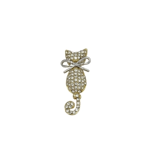 Chic gold-plated cat brooch featuring sparkling crystals and a silver bow detail