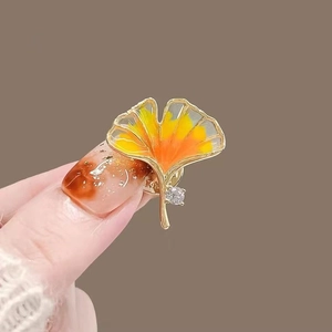 Exquisite golden ginkgo leaf brooch with warm gradient colors and zircon embellishment