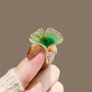 Exquisite golden ginkgo leaf ring with green enamel and sparkling zircon accents