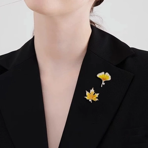 Vintage maple and ginkgo leaf brooches with yellow enamel and zircons on a black blazer